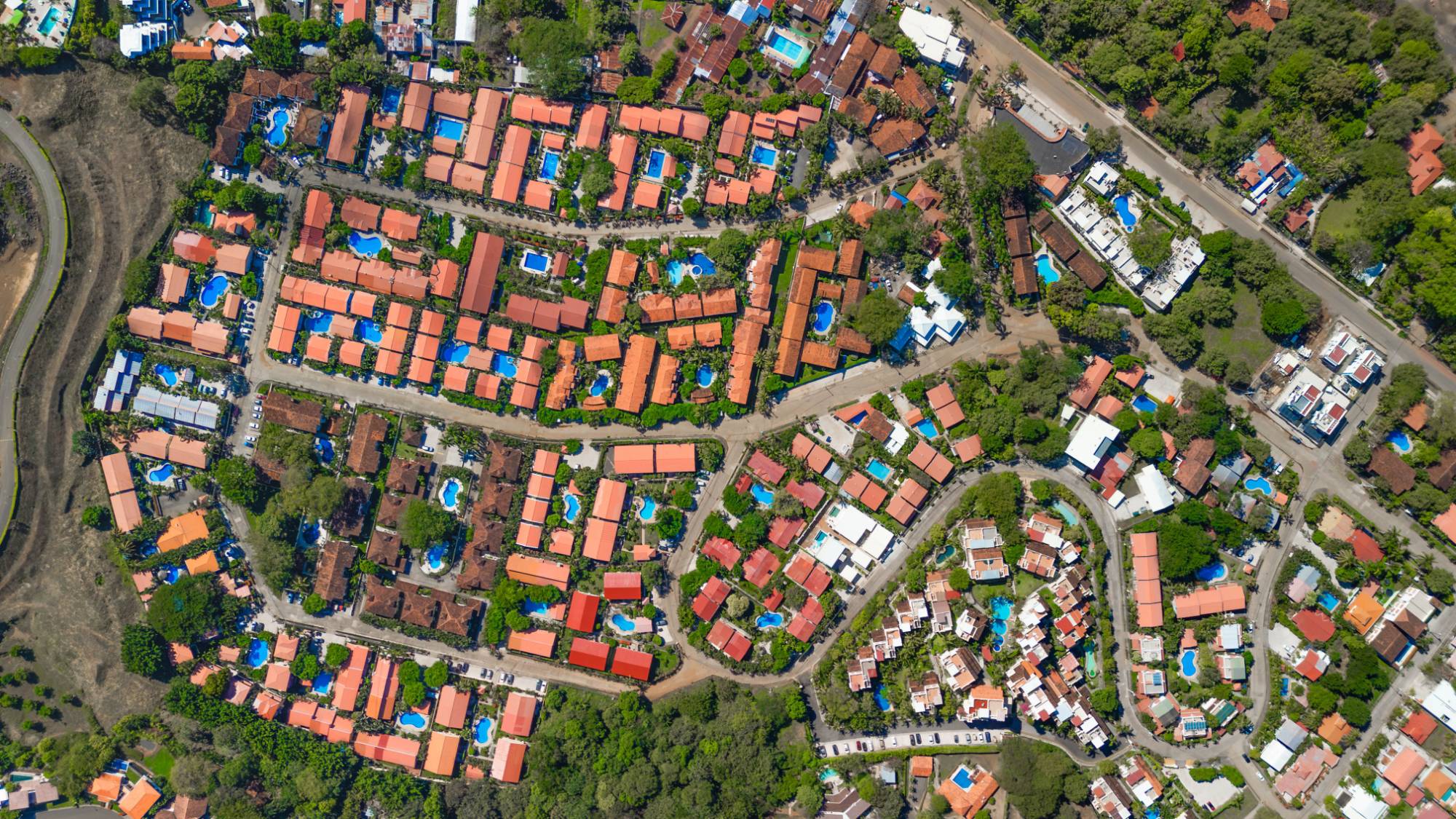 Aerial view of the Las Palmas neighborhood in Playas del Coco, Guanacaste, Costa Rica, showing dense clusters of condos and homes with private pools