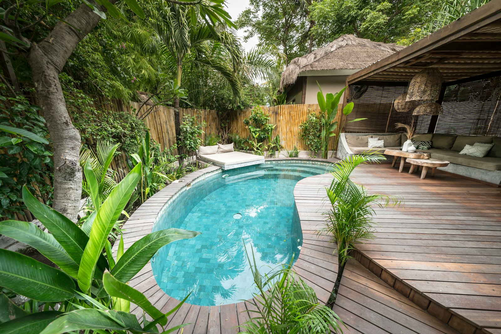 A tropical vacation rental villa with a private pool surrounded by palm trees