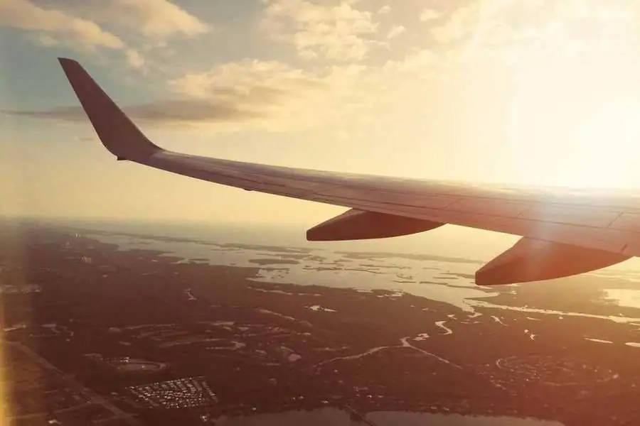Airplane wing over the coastline, symbolizing Guanacaste's tourism growth