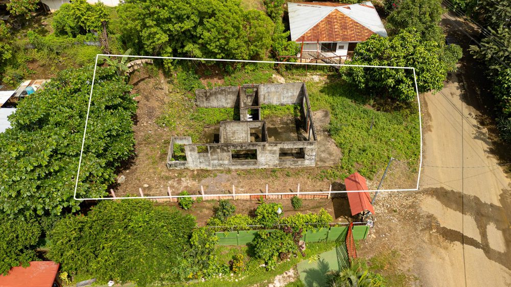 Closer aerial view of the lot showing the existing concrete foundation