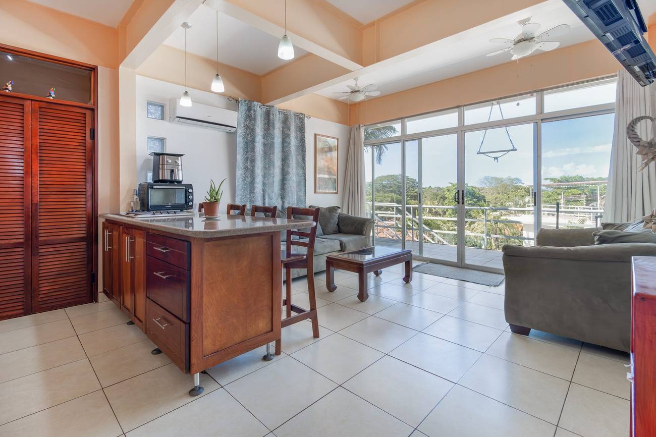 Tucanes #5 condo living room with balcony and bay view